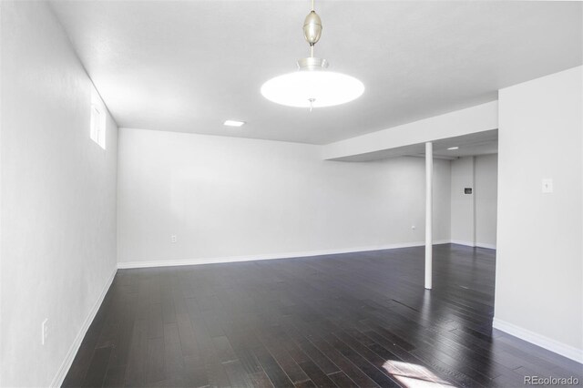 below grade area featuring baseboards and wood finished floors