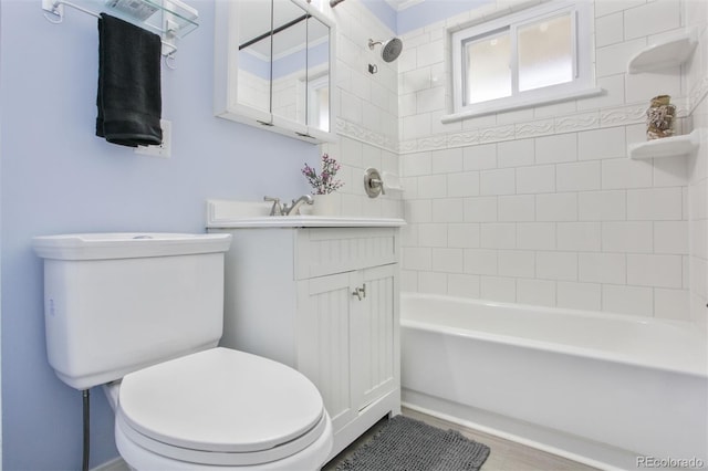 bathroom featuring tub / shower combination, vanity, and toilet