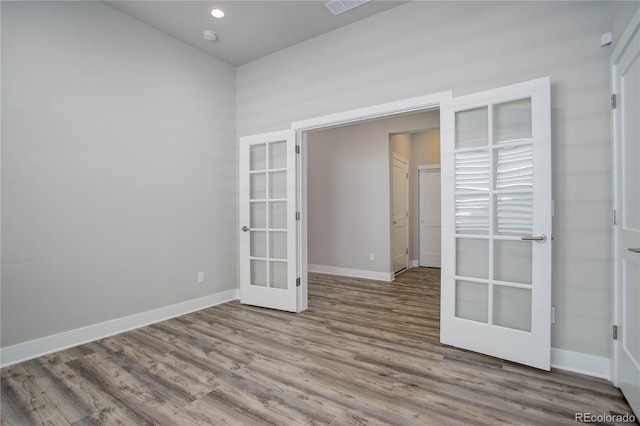 unfurnished room with wood-type flooring and french doors