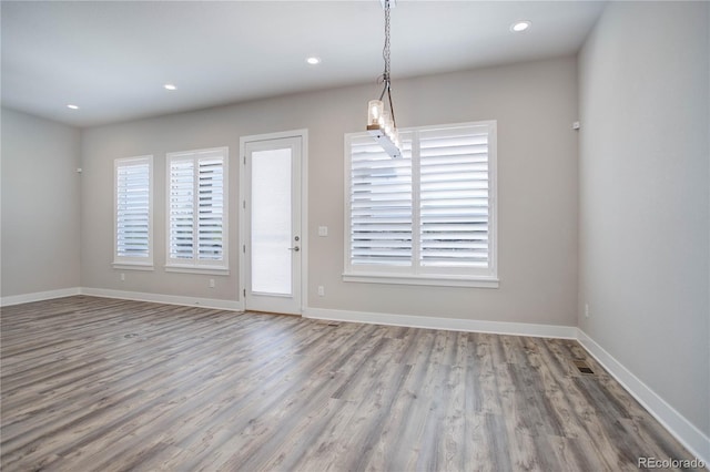 unfurnished dining area featuring light hardwood / wood-style floors