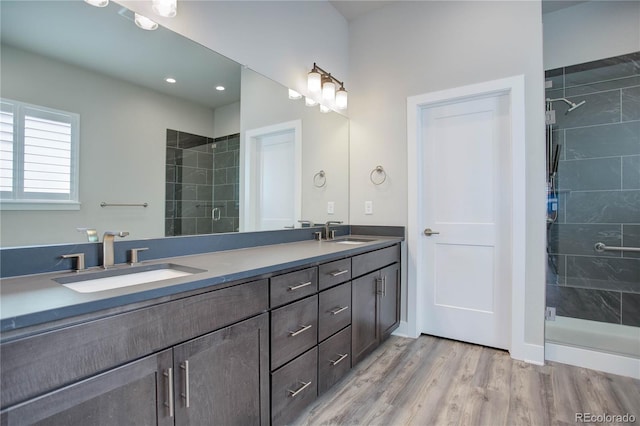 bathroom featuring an enclosed shower, vanity, and hardwood / wood-style flooring