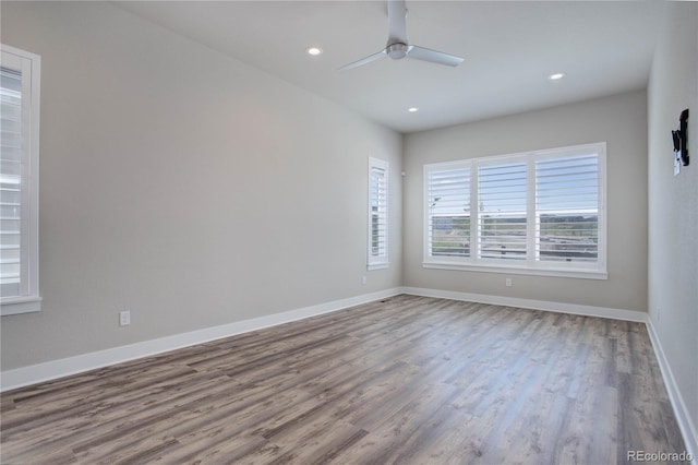 spare room featuring hardwood / wood-style floors and ceiling fan