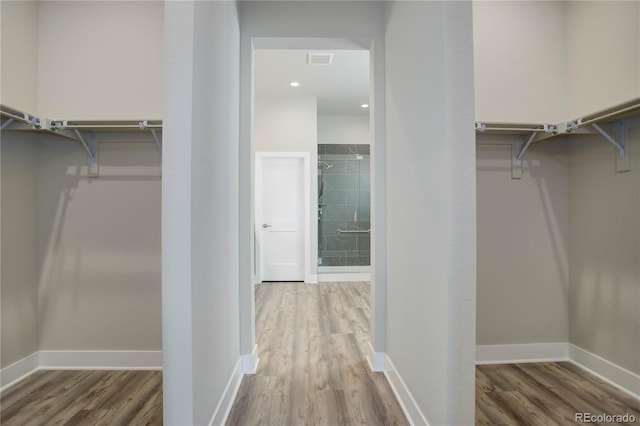 spacious closet featuring hardwood / wood-style flooring