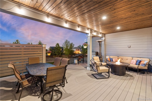 5181 Appleton Way, Castle Rock, CO 80104 - deck at dusk with outdoor dining space and an outdoor living space with a fire pit
