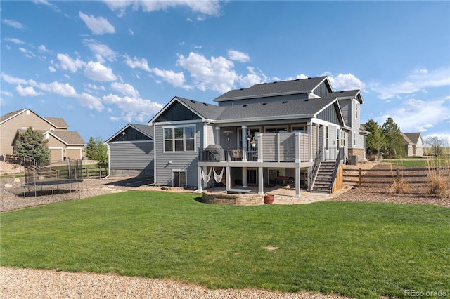 5181 Appleton Way, Castle Rock, CO 80104 - back of house featuring board and batten siding, a trampoline, stairs, a deck, and a patio area