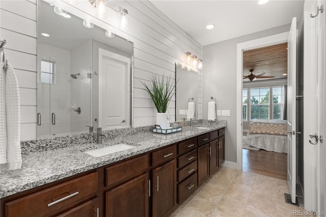 5181 Appleton Way, Castle Rock, CO 80104 - ensuite bathroom featuring double vanity, a shower stall, ceiling fan, and recessed lighting