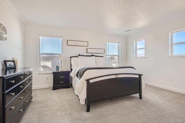 carpeted bedroom featuring ornamental molding and a textured ceiling