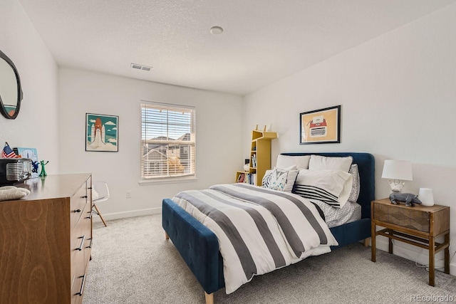 carpeted bedroom featuring a textured ceiling