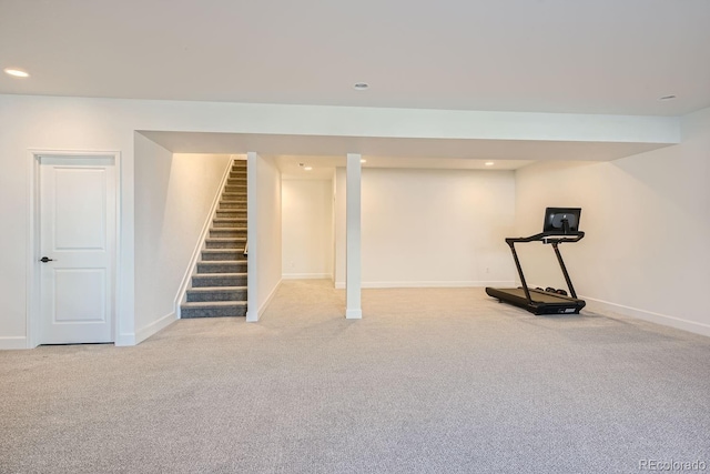 basement featuring light colored carpet