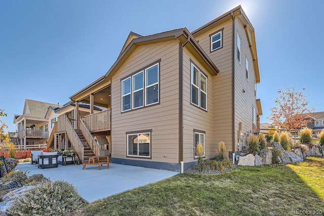 back of property featuring a patio and a yard