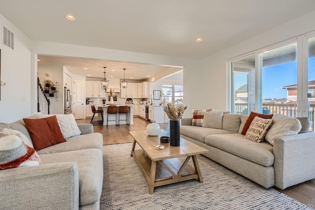 living room with sink and light hardwood / wood-style flooring