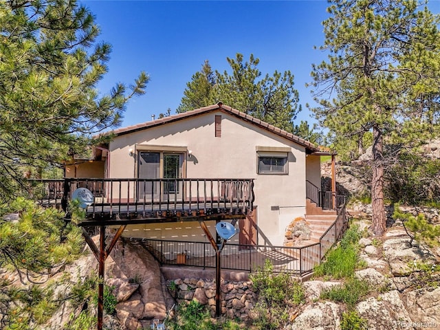 5336 High Rd, Evergreen, CO 80439 - back of house featuring a deck, stucco siding, and stairway