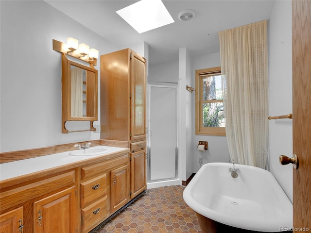 5336 High Rd, Evergreen, CO 80439 - bathroom with a skylight, a freestanding bath, vanity, and a stall shower