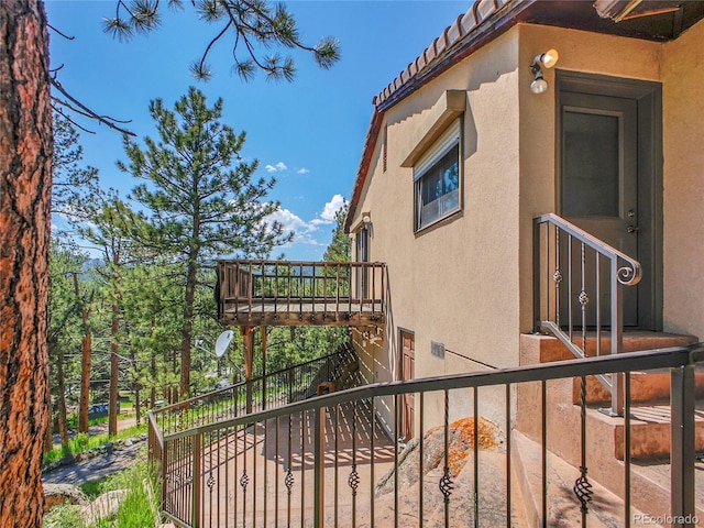 5336 High Rd, Evergreen, CO 80439 - view of side of home with stucco siding, stairway, and a tile roof