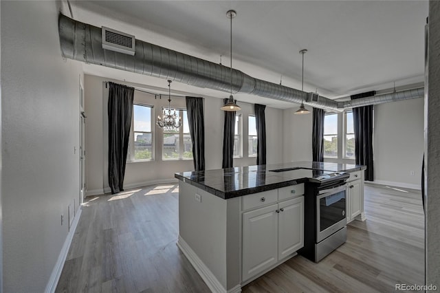 kitchen with decorative light fixtures, tile countertops, visible vents, white cabinets, and stainless steel electric range