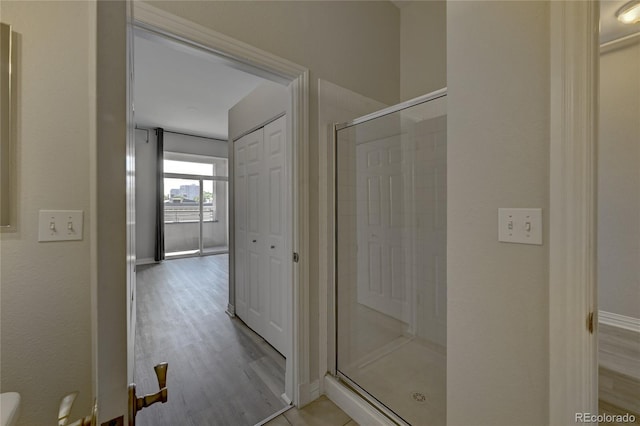 bathroom featuring hardwood / wood-style floors and an enclosed shower