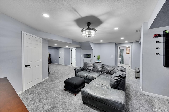 carpeted living room with a textured ceiling