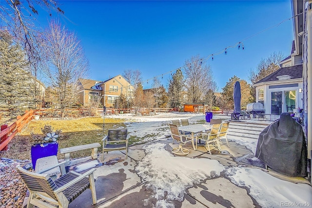 snow covered patio with area for grilling