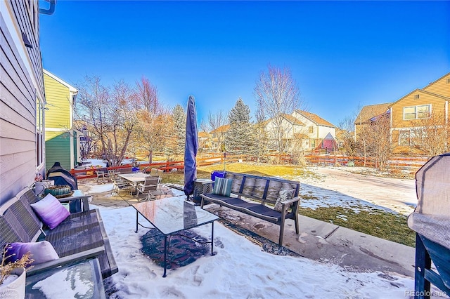 snow covered patio featuring an outdoor living space