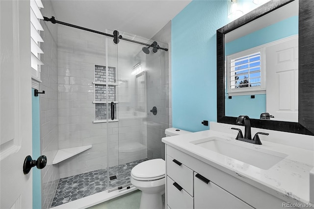 bathroom with vanity, an enclosed shower, and toilet