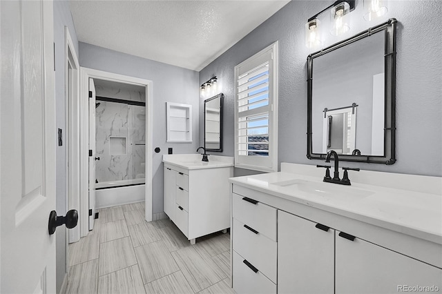 bathroom with vanity, a textured ceiling, and shower / bathing tub combination