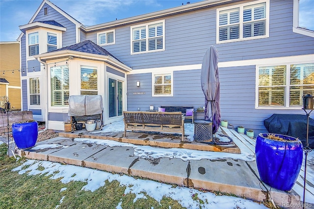 snow covered property with an outdoor hangout area