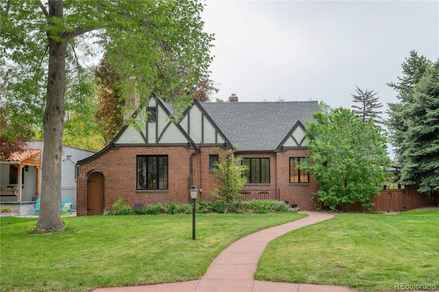 770 Locust, Denver, CO 80220 - tudor home with brick siding, a chimney, and roof with shingles