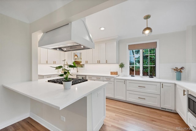 770 Locust, Denver, CO 80220 - kitchen featuring island range hood, stainless steel appliances, decorative backsplash, white cabinets, and light wood-style floors
