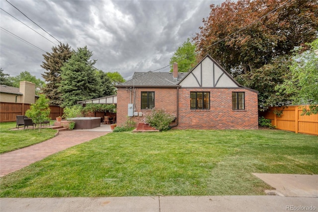 770 Locust, Denver, CO 80220 - view of front of house with a hot tub, a patio area, brick siding, a chimney, and a shingled roof