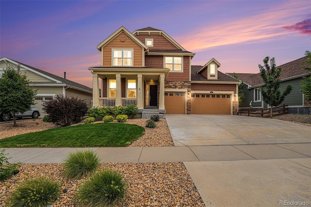 craftsman inspired home with a garage and covered porch