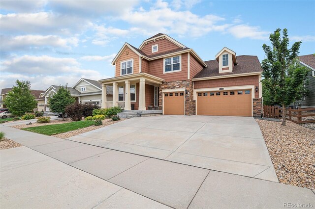 craftsman-style house with a garage and covered porch