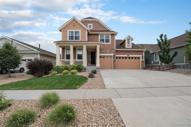 craftsman-style home featuring a garage and covered porch