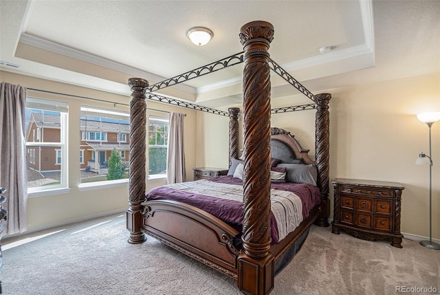 carpeted bedroom featuring visible vents, baseboards, a raised ceiling, and crown molding