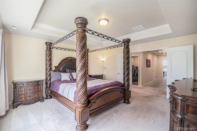 carpeted bedroom featuring visible vents, a raised ceiling, and crown molding