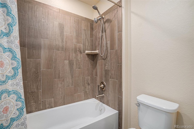 bathroom with a textured wall, toilet, and shower / bath combo with shower curtain