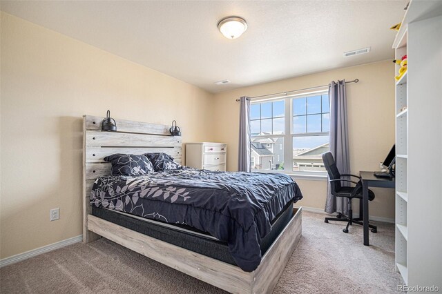 carpeted bedroom featuring visible vents and baseboards