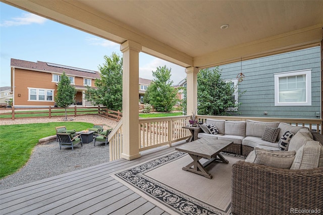 wooden deck with fence and an outdoor living space