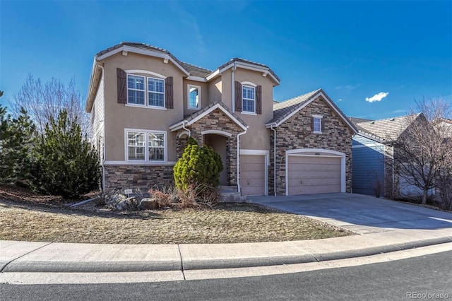 traditional-style house with stucco siding, concrete driveway, an attached garage, stone siding, and a tiled roof