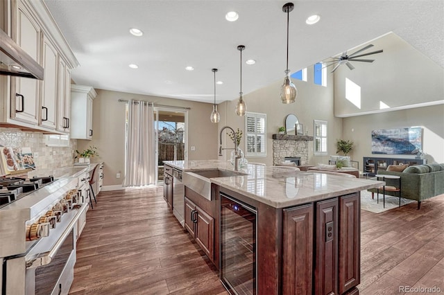 kitchen with dark wood-type flooring, beverage cooler, extractor fan, and a sink