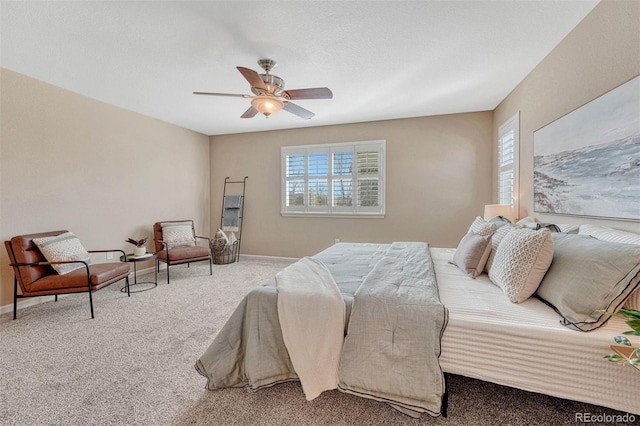 carpeted bedroom with a ceiling fan and baseboards