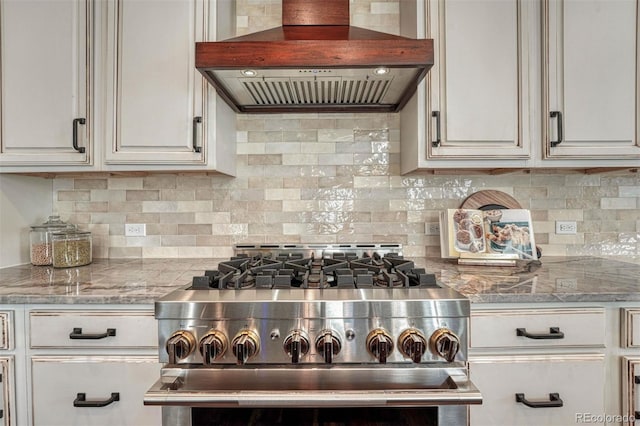 10761 Hillsboro Cir, Parker, CO 80134 - kitchen featuring custom range hood, stainless steel range with gas stovetop, decorative backsplash, and light stone counters