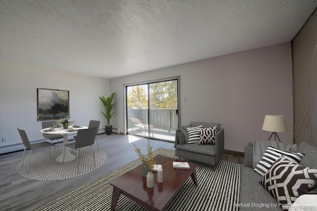 living room with hardwood / wood-style flooring, a textured ceiling, and a baseboard heating unit