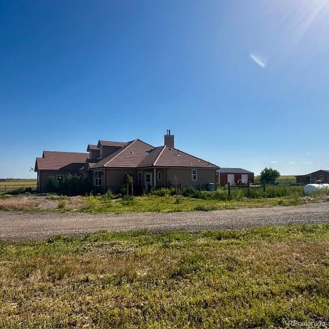 13291 N Harback Rd, Bennett, CO 80102 - rear view of property with a tiled roof