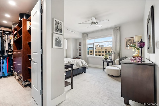 bedroom featuring light colored carpet and ceiling fan