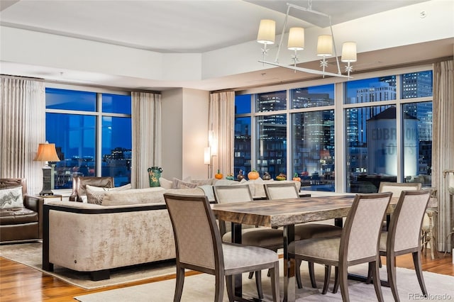 dining area with an inviting chandelier and wood finished floors