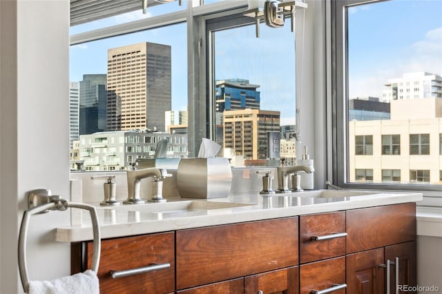 interior space featuring a healthy amount of sunlight, a city view, and a sink