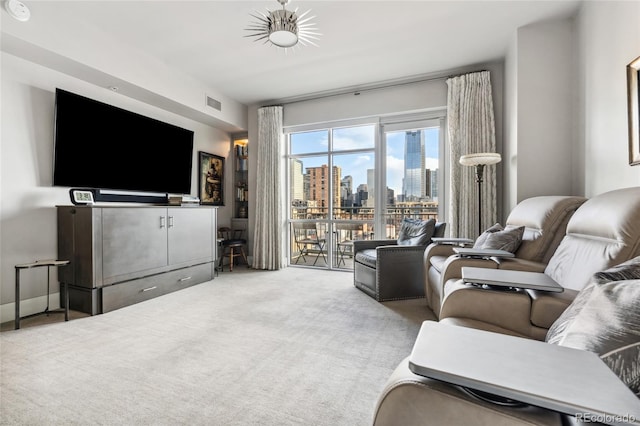 living area with visible vents and light colored carpet