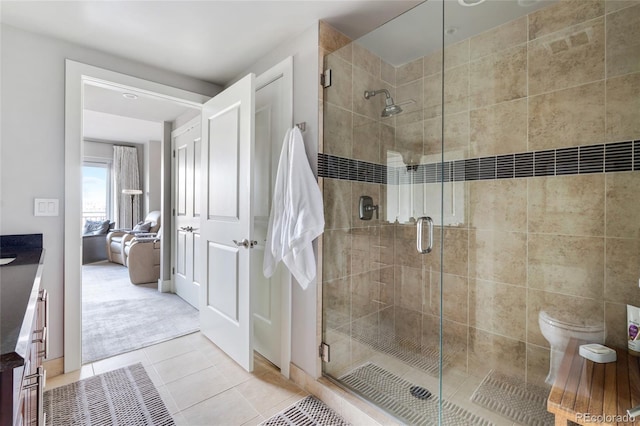 1411 Wynkoop St Unit 806, Denver, CO 80202 - ensuite bathroom featuring a stall shower, tile patterned floors, vanity, and toilet