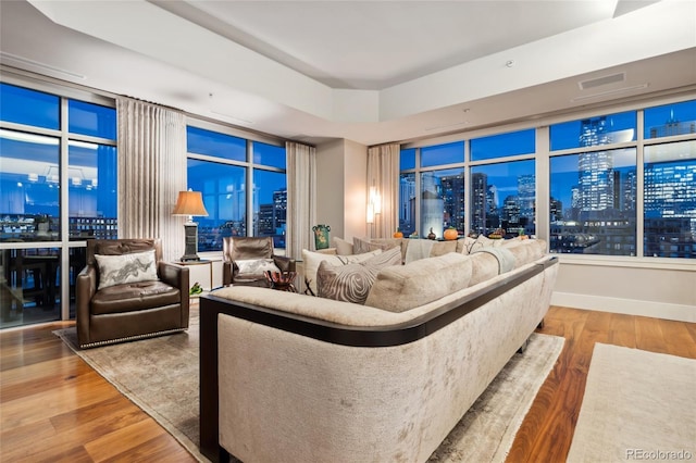 1411 Wynkoop St Unit 806, Denver, CO 80202 - living area with wood finished floors, a city view, and a raised ceiling