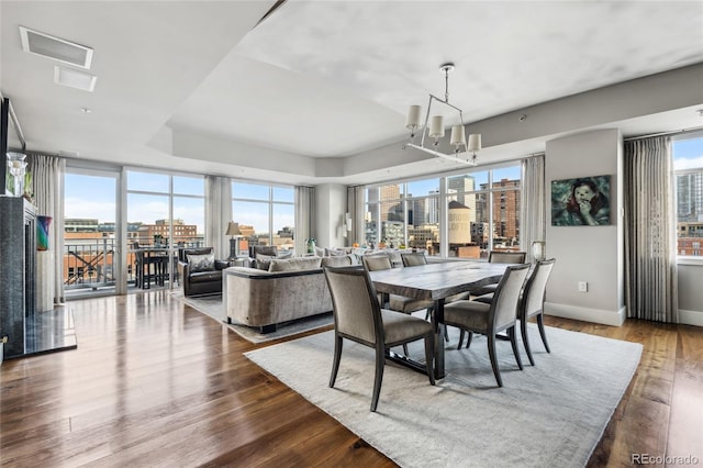 1411 Wynkoop St Unit 806, Denver, CO 80202 - dining space with a city view, a chandelier, dark wood-type flooring, and baseboards